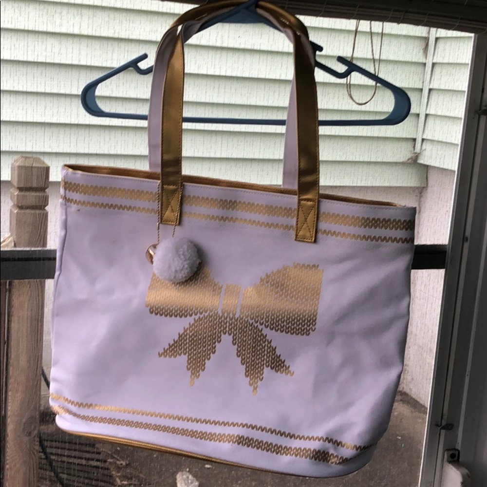 White and gold bag with a bow